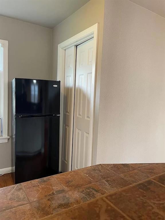 Kitchen with freestanding refrigerator