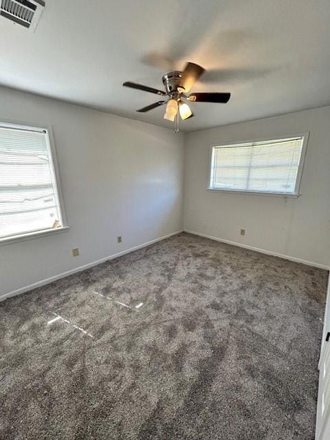 Spare room featuring carpet flooring, ceiling fan,