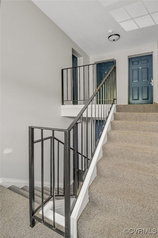 Stairway to upper unit, middle door of three doors