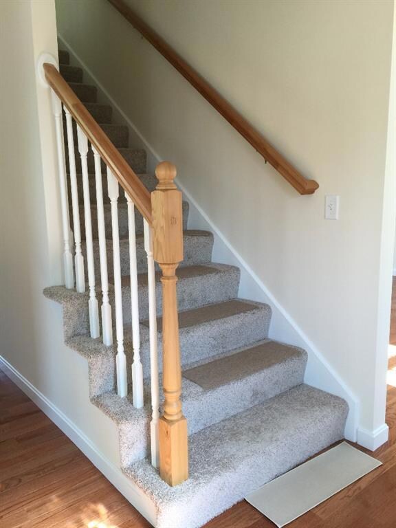 Carpeted stairs to second floor from...