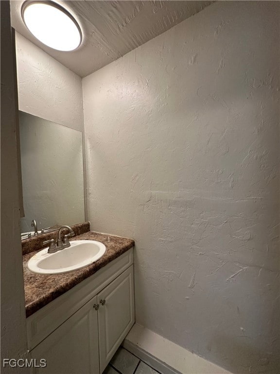 Bathroom with vanity, tile patterned floors, and a