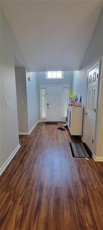 Entryway featuring dark wood finished floors and baseboards