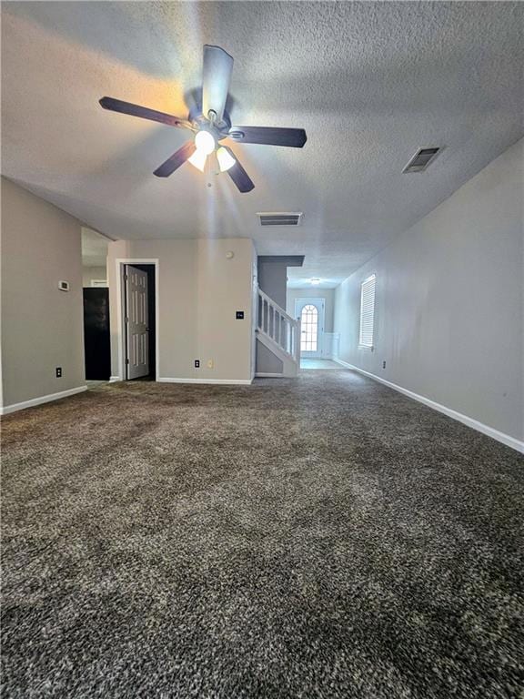 Unfurnished living room with ceiling fan, a textured ceiling, and carpet