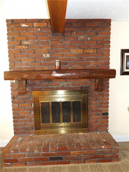 Beautiful brick fireplace located in the family ro