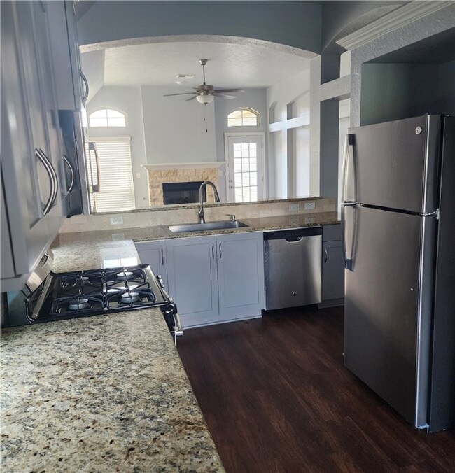Kitchen featuring stainless steel appliances, a si