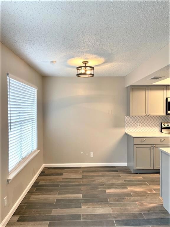 Unfurnished dining area with dark wood-type floor