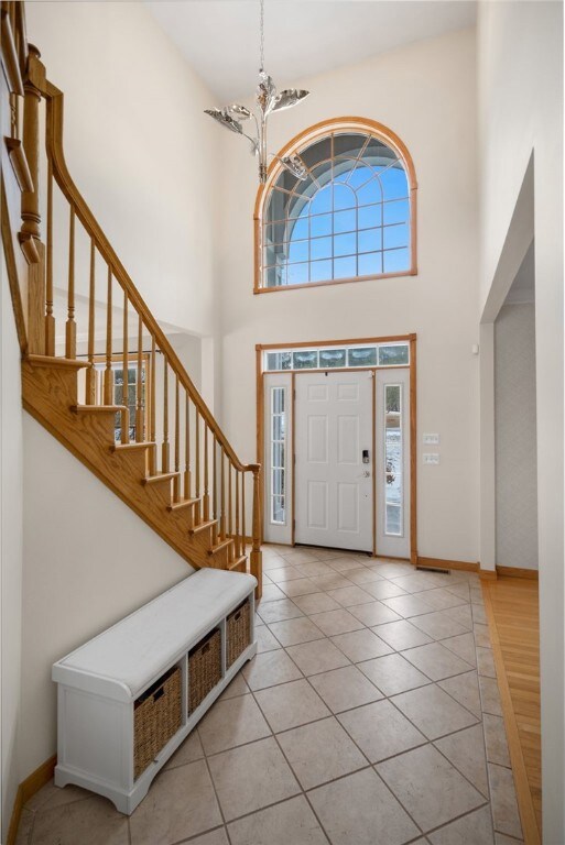 Large entryway with tiled floors and large windows