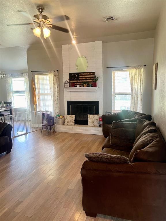 Living room with a brick fireplace, a wealth of na