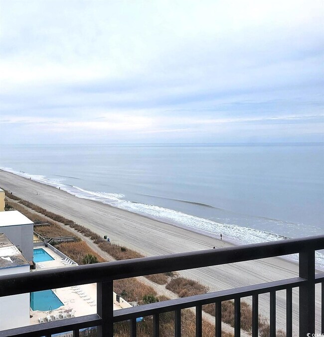Property view of water with a beach view