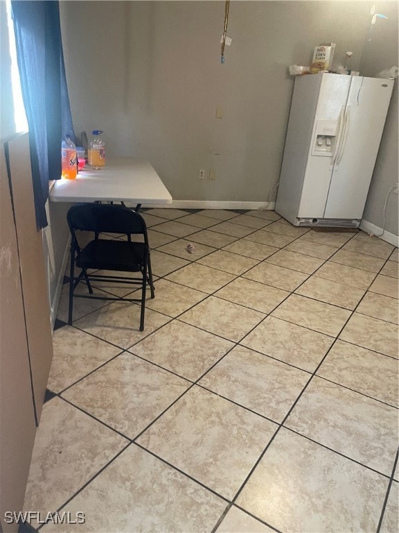 Dining space featuring light tile patterned floors