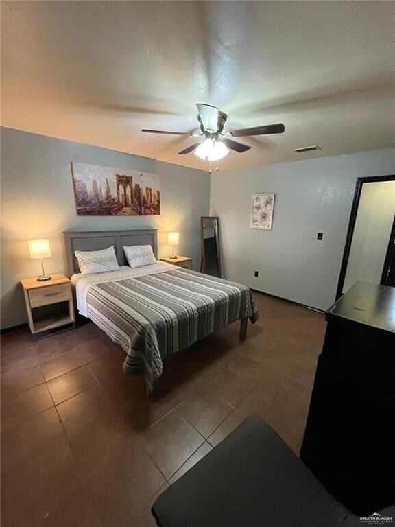 Tiled bedroom with ceiling fan