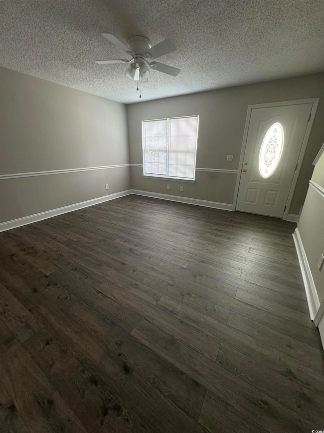 Interior space with dark wood finished floors, a t