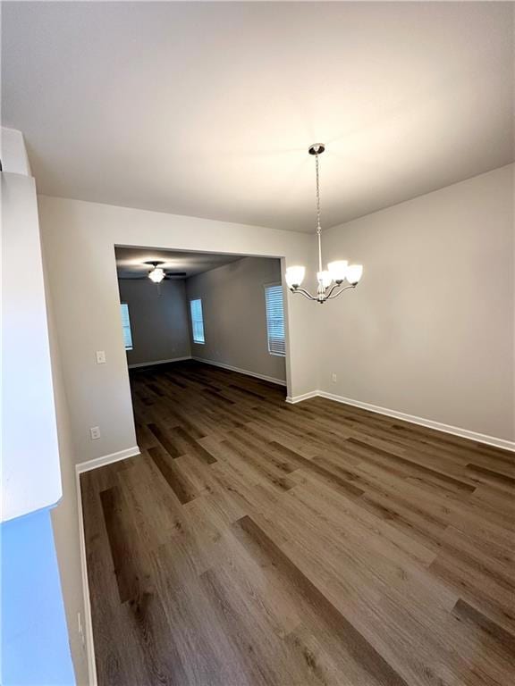 Unfurnished dining area with dark hardwood / wood-