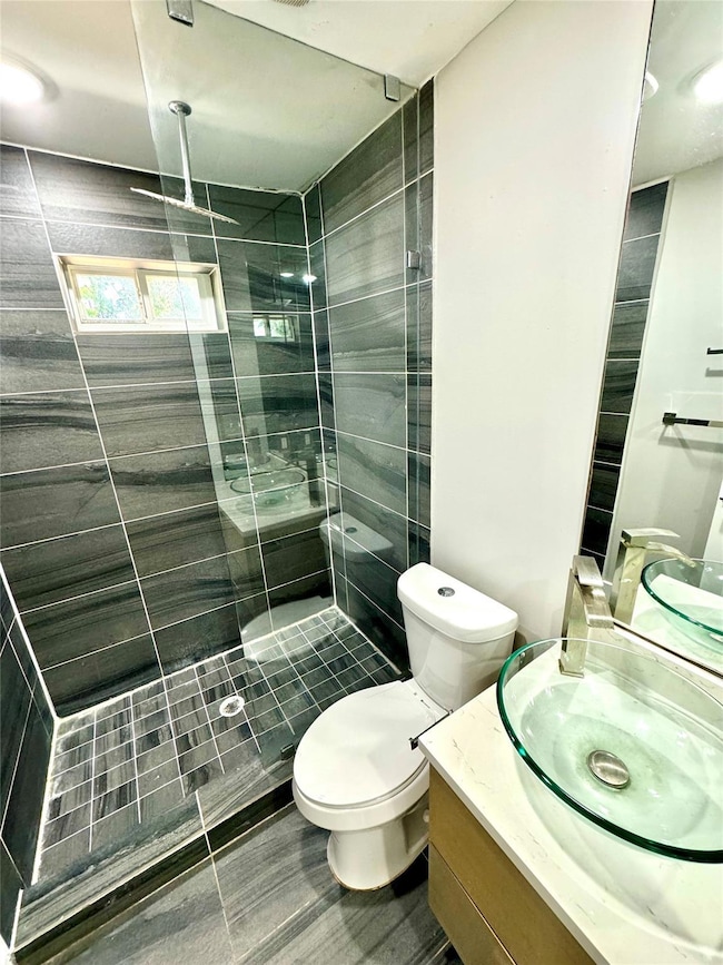 Bathroom with tile patterned floors, toilet, vanit