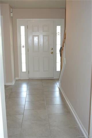 Inviting spacious foyer with recent tile floor.