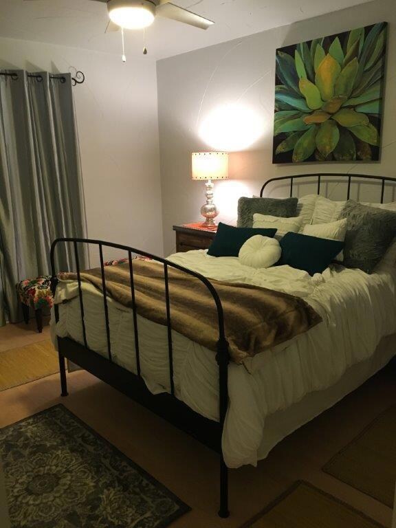 Bedroom with wood finished floors and ceiling fan