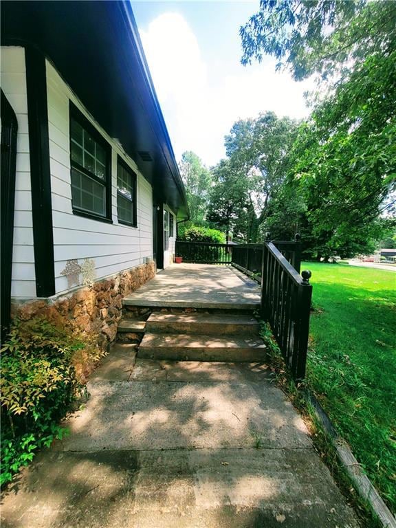View of side of home featuring a yard