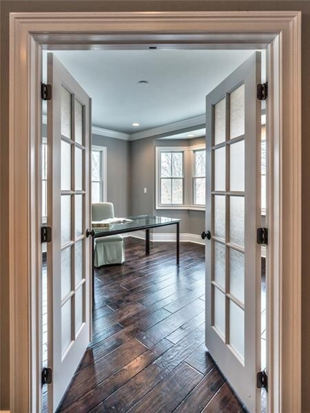The private study/den with crown moulding, bay window and French doors.