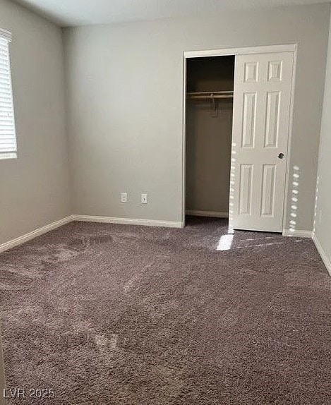 Unfurnished bedroom featuring baseboards, carpet,