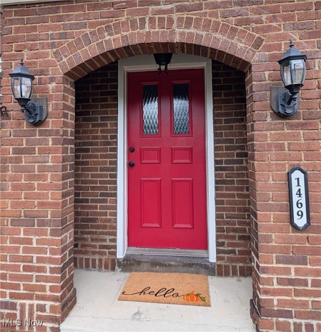 Entrance to property with brick siding