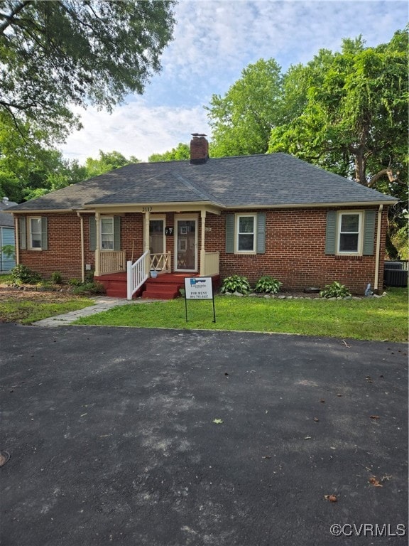 View of front of house featuring brick siding, a c