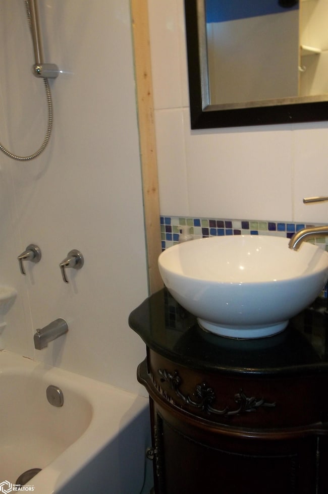 Bathroom has black granite tile floors
