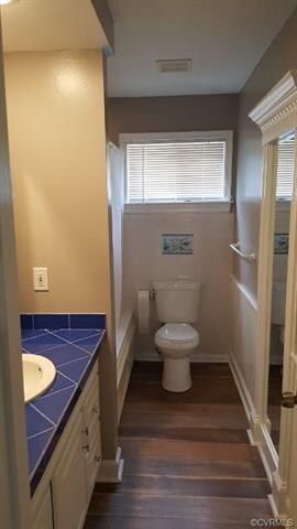 Hall full bath with hardwood, trim and tile sink s