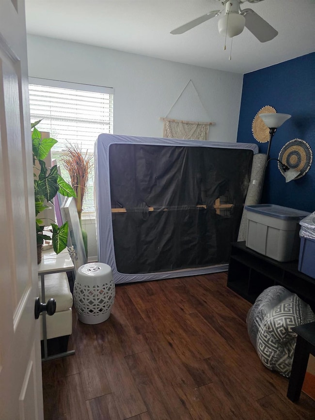 Bedroom with wood finished floors and a ceiling f