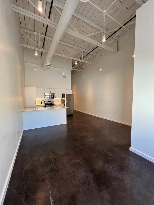 Garage with stainless steel fridge and sink