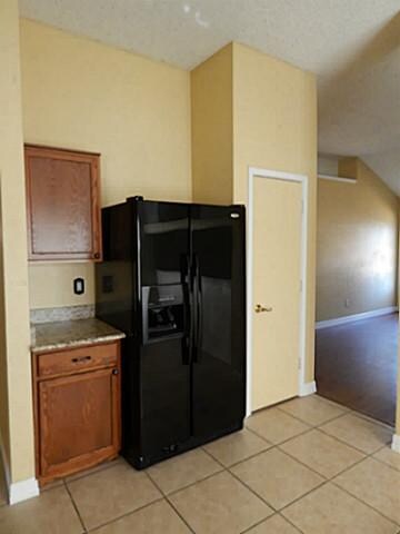 Kitchen with Whirlpool side by side refrigerator a