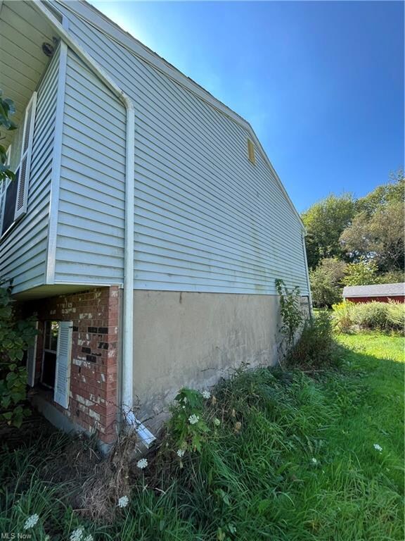View of side of property with a yard