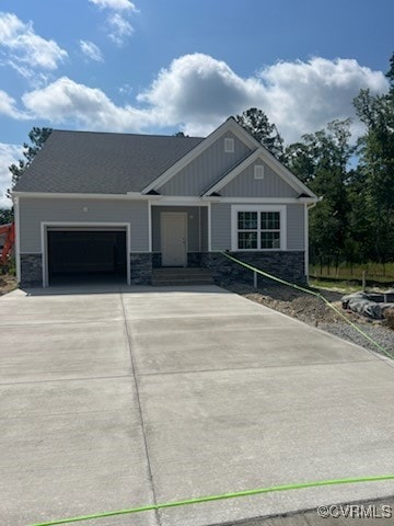 Craftsman inspired home with a garage, concrete dr