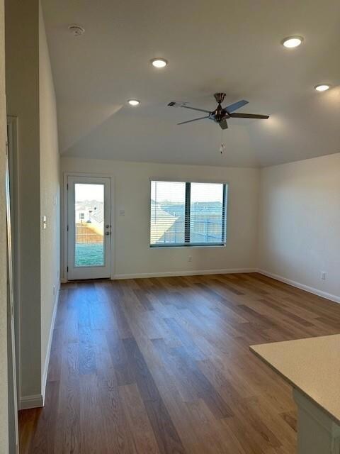 Unfurnished room featuring ceiling fan, wood fini