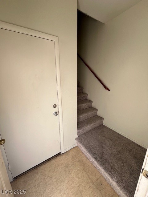 Stairway featuring tile patterned floors