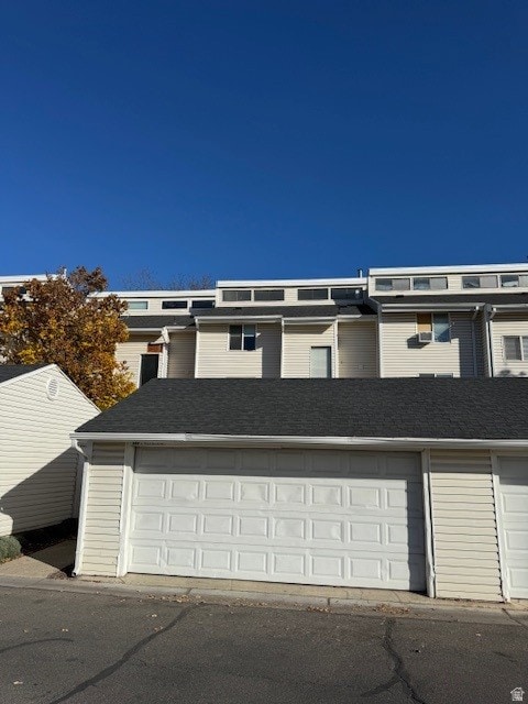 View of front of property with a shingled roof
