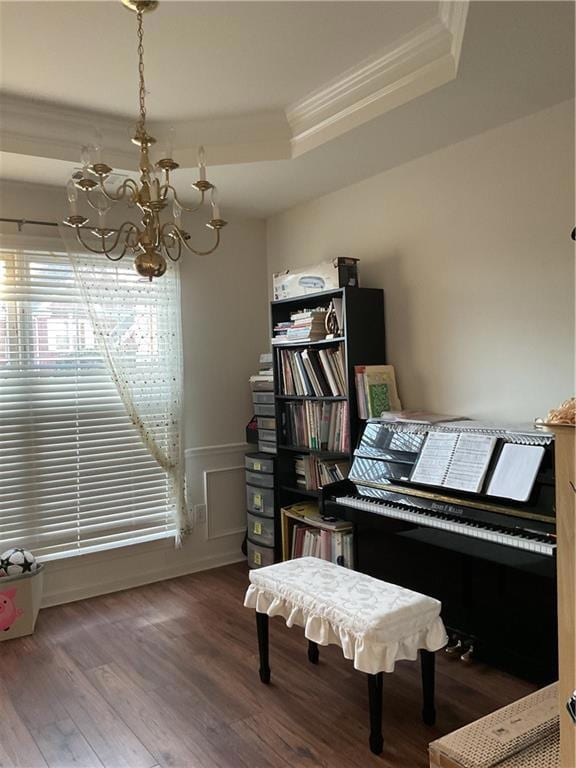 Miscellaneous room featuring a tray ceiling, hardw