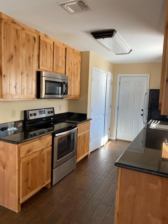 Kitchen with granite counters, light brown cabinet