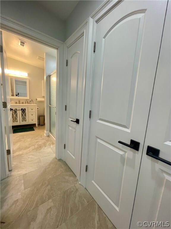 Corridor with light tile patterned floors