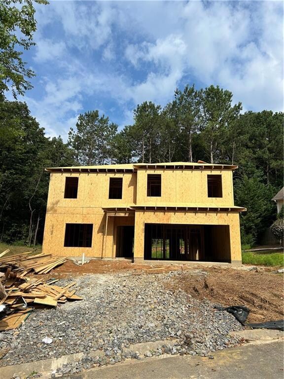 Unfinished property with stucco siding and a garage