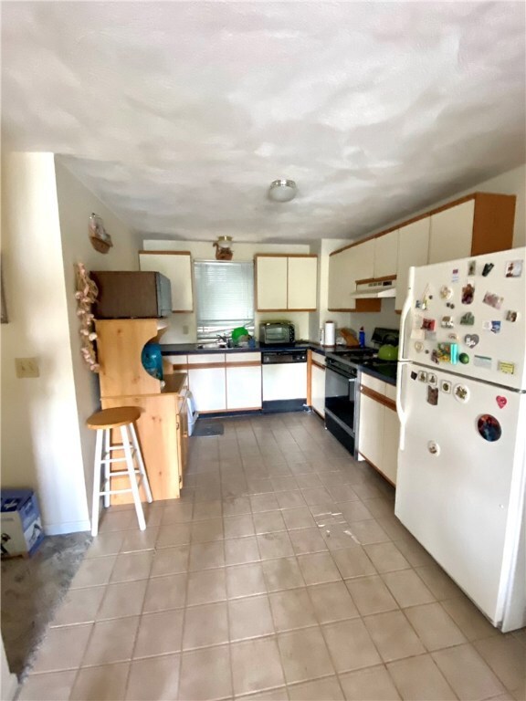 kitchen.  Tile floor needs repair.
