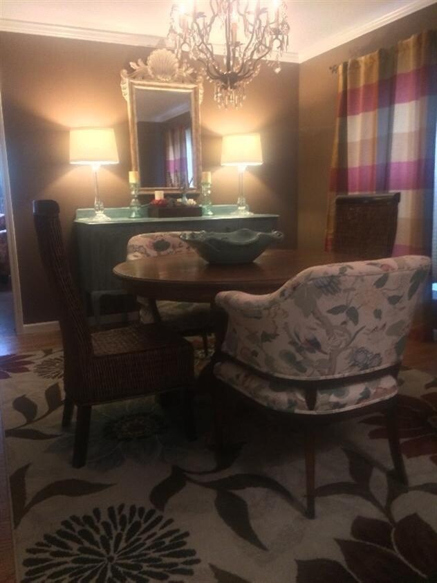 Formal dining room with elegant chandelier & hardwood floors