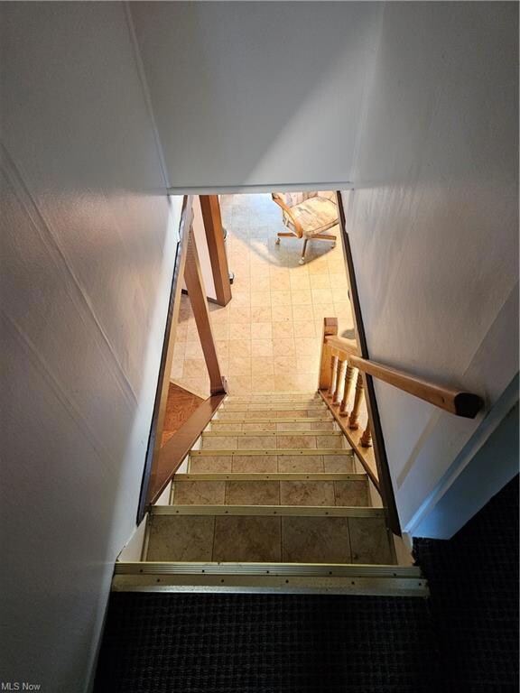 View of staircase from the second floor to the fir