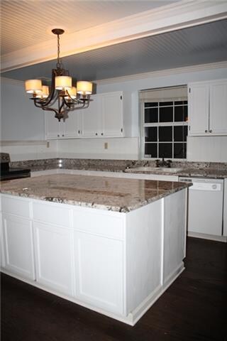 This GORGEOUS kitchen has been fully renovated with white cabinets, stunning high end granite, wood floors, a farm sink and bead board accent walls and ceilings! The colors in this kitchen are beautiful!