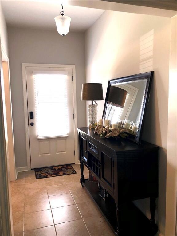 FOYER, CERAMIC TILE, GRAY TONE WALLS.
