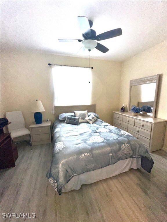 Bedroom featuring ceiling fan and wood-type floori