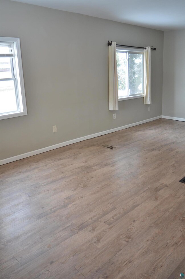 Spare room featuring light hardwood / wood-style f