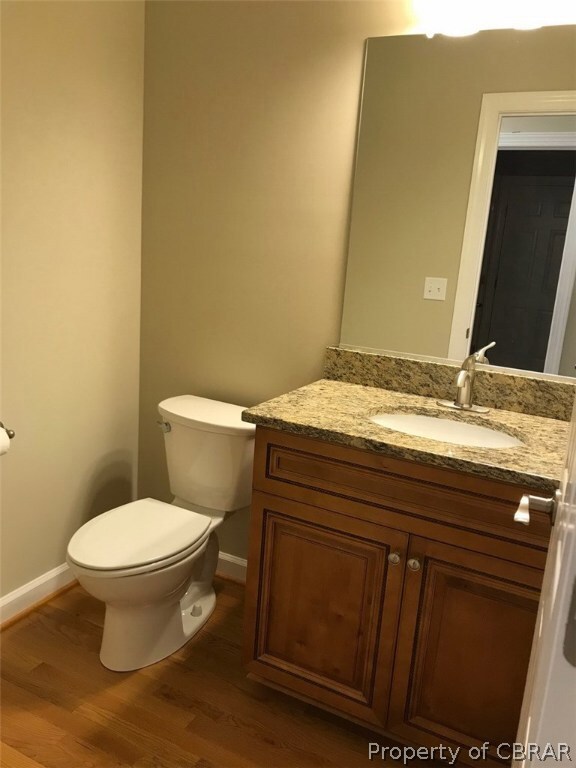Half bath with wood floor and Granite counter
