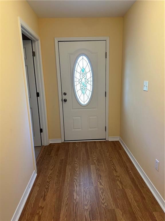 Foyer entrance featuring wood finished floors and baseboards