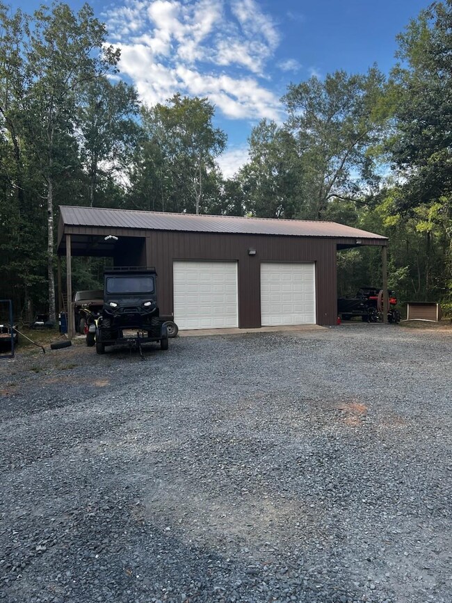 30'x30' shop with 2 10' covered parking areas