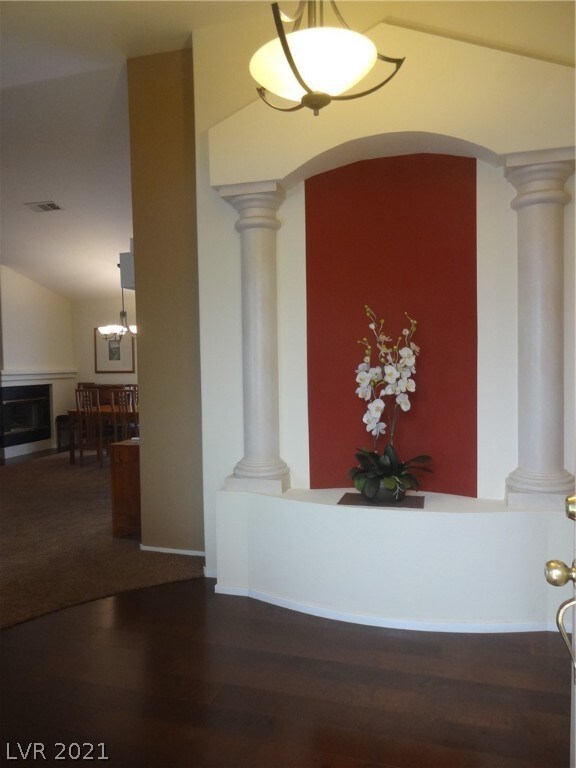 Entry foyer with art niche and decorative columns.